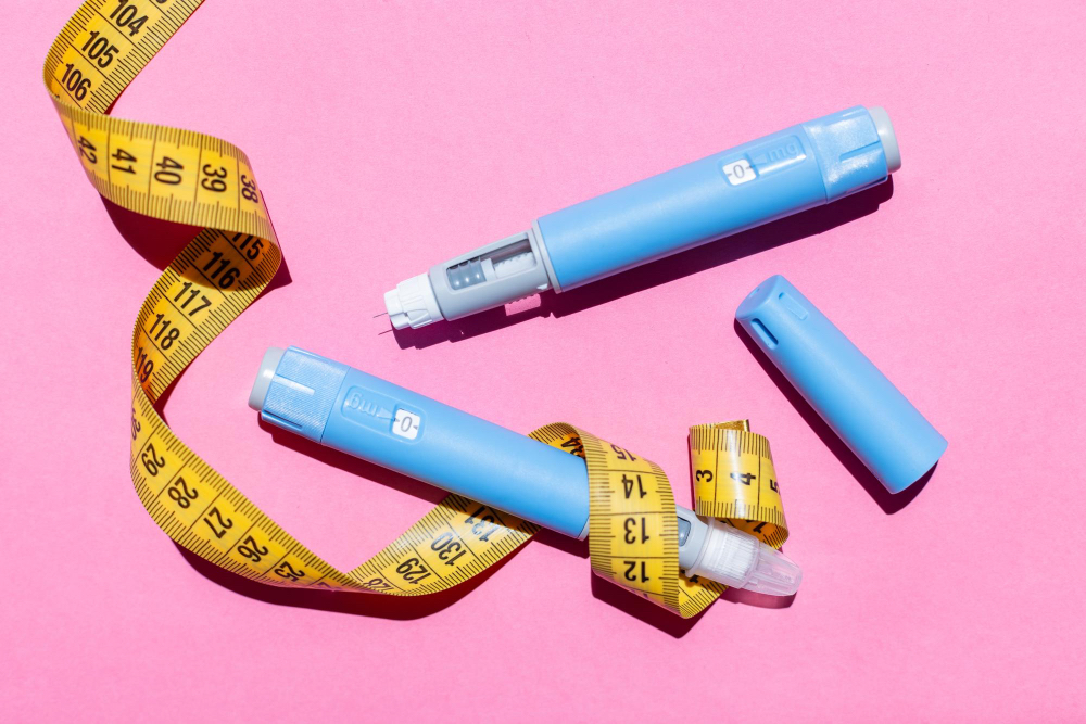 Weight loss medication pens and measuring tape