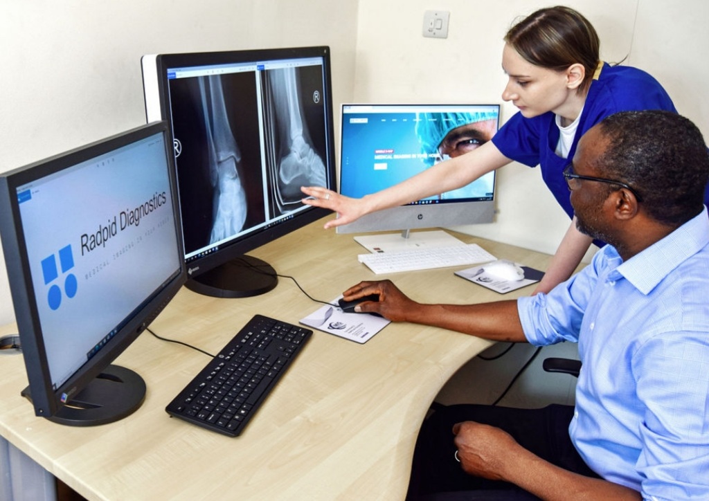 Digital X-ray service with radiographer preparing a patient